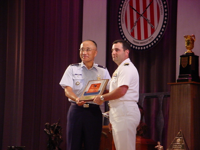 Col Chang presenting the Fleet Admiral Nimitz Award to CDR Gino Celio, USNR