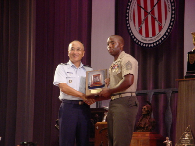 Col Chang presenting the McMillan Trophy to GySgt Richard Gray, USMC