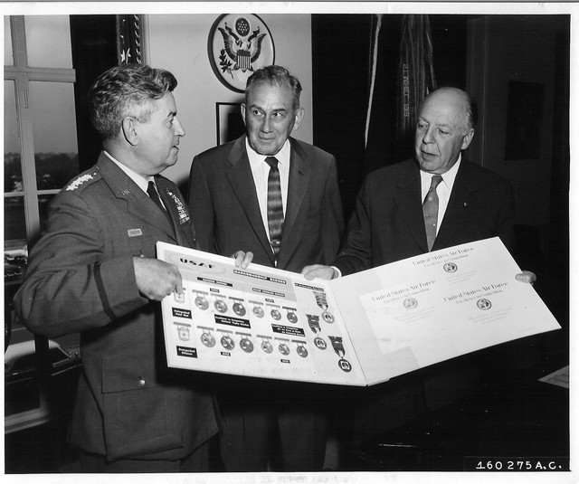 Gen Curtis LeMay, Assistant Secretary Hugh Milton II, Secretary Wilber Brucker
General Curtis E. LeMay, Vice Chief of Staff, United States Air Force, presented a display of the recently established Air Force Distinguished Marskmanship Badges to Secretary of the Army, the Honorable Wilber M. Brucker.  The ceremony took place in the Secretary's office.  General LeMay instituted the Air Force Marksmanship Training and Competitive Program last year.  Secretary Brucker gave the disply of badges to the Assistant Secretary of the Army, the Honorable Hugh M. Milton II, President of the National Board for the Promotion of Rifle ractice.  The NBPRP serves all military service and civilian shooting organizations and is administered by the Army.  The Air Force Distinguished Marskmanship Badges will be permanently displayed in the offices of the NBPRP, with other military service and civilian Distinguished Marksmanship Badges.