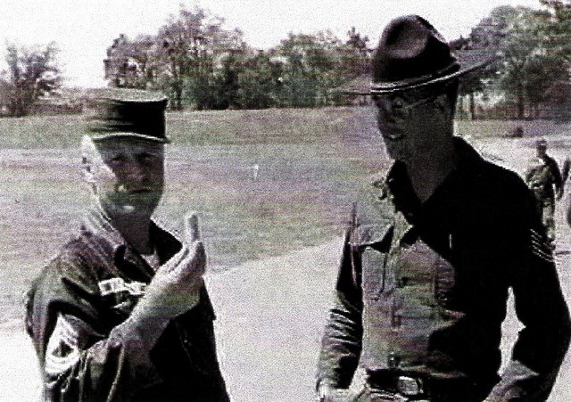 Army MTU SgtMaj Don Berger eating carrots while TSgt Eugene O. Reinartz looks on