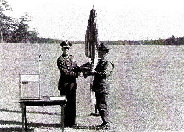 The Commander of the US Army Marksmanship Unit presenting the award, reluctantly, to the Captain of the losing Team
