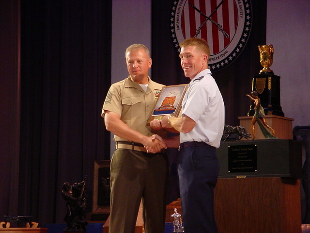 GySgt Zins accepting the Military Police Corps Award from Col(s) Teskey