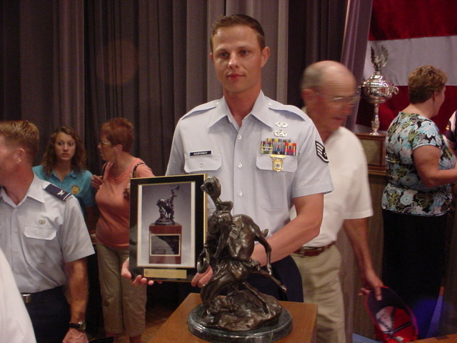 TSgt(s) Aguryanov with his Harold R. Krelstein Award and Trophy