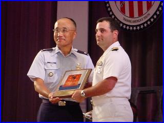 Col Chang presenting the Fleet Admiral Nimitz Trophy to CDR Gino Celio
