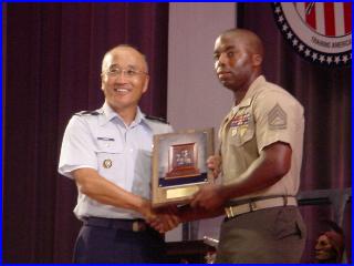 Col Chang presenting the McMillan Trophy to GySgt Richard Gray